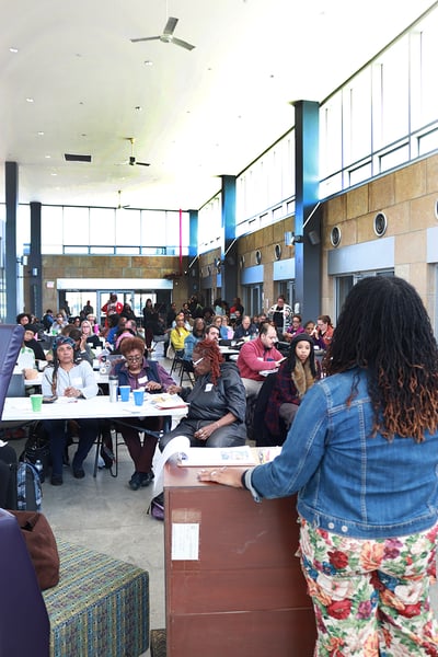Shamyle speaks to attendees at a workshop.